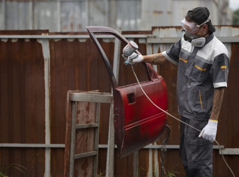 man-spraying-powder-paint-car-door-medium-shot